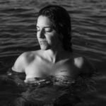 Tranquil black and white portrait of a woman in water, capturing serene beauty.